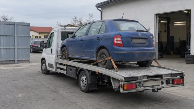 Bílý odtahový vůz s upevněným vozidlem Škoda na hliníkové plošině